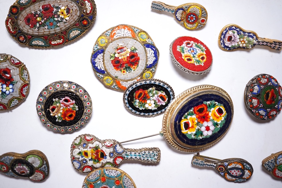 A collection of twenty-eight brooches, including fourteen mixed guitar and banjo shaped brooches, six large oval brooches, seven smaller brooches and one small oval., Condition - good